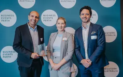 Micheal Piu, Caitlin Skinner and a Business Events Perth representative standing in front of a Business Events screen 