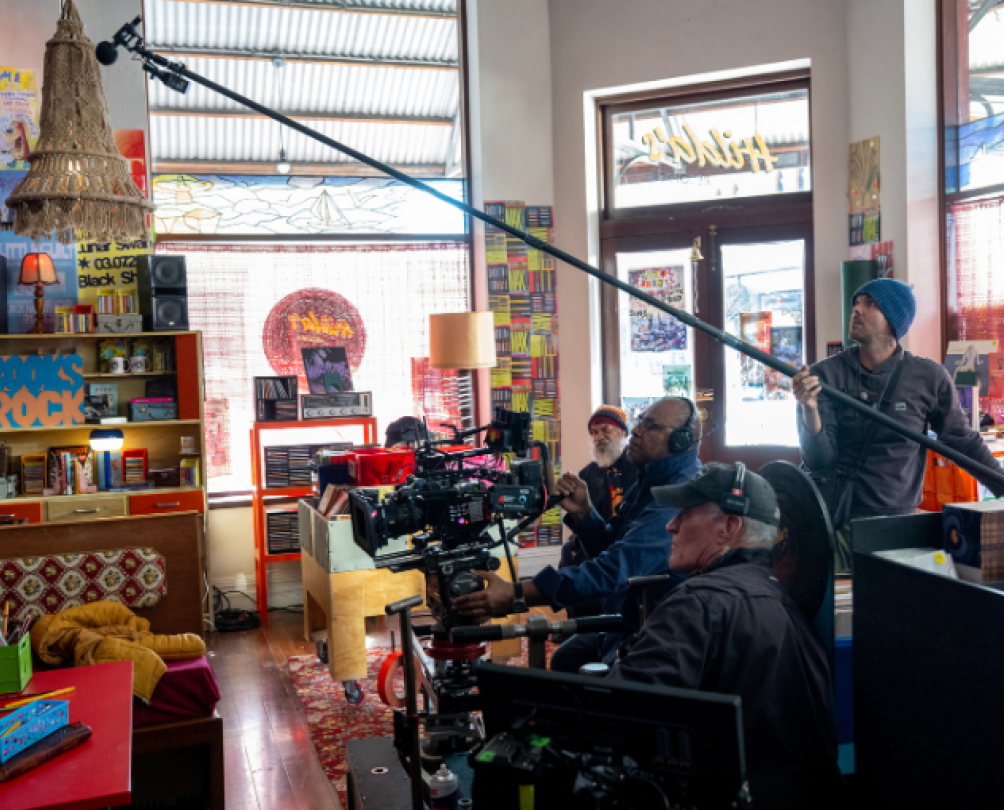 a bunch of cameras and a camera crew in a book shop
